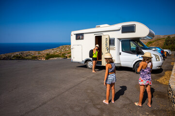 Family with a motorhome RV parked Preveli beach, Crete, Greece.