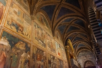 San Gimignano, Italy, 15 April  2022: Beautiful frescoes in the medieval cathedral