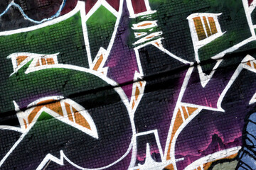 Colorful background of graffiti painting artwork with bright aerosol strips on metal wall. Old...