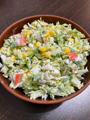 large vertical photo. homemade food. salad with Chinese cabbage and crab imitation. balanced salad. healthy food. eco. bio. Russian traditional salad for the holidays.