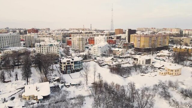 Bird's eye view of a snow-covered urban residential area. New buildings in a modern metropolis. Solution of the housing problem. City of Vladimir, Oktyabrsky district. UHD 4K.