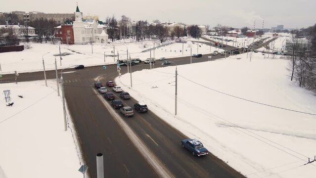 Top view from a bird's eye view of a city road with cars. Vehicles drive and stand at a traffic light. Regulated intersection, interchange. City of Vladimiro, Lybidskaya highway. UHD 4K.