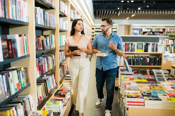 Young woman and man shopping at the book store