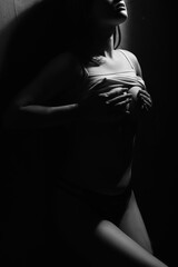woman covers her breast. perfect body girl, black and white photo