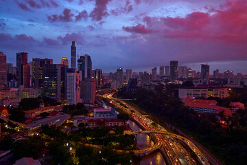 Fototapeta na wymiar An incredible pink and purple sunset over a modern big city