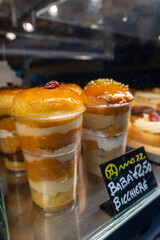 Typical Neapolitan cake called Babà, in a window of a pastry shop in the city of Naples