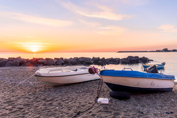 nice old vintage boat on a sea coast with picturesque view on a sunrise in a rocky gulf