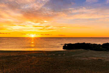 Fototapeta premium morning or evening landscape with nice beach during sunrise or sunset in sea with amazing isle with rocks and beautiful clouds on background