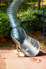 Stainless steel cylinder slide in the park playground