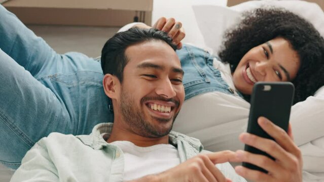 Phone, love and social media with a diversity couple in their home together to relax over the weekend. Smartphone, technology and internet with a man and woman bonding in the living room of a house