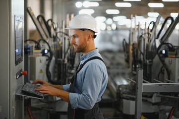 Factory for aluminum and PVC windows and doors production. Manual worker assembling PVC windows and doors.