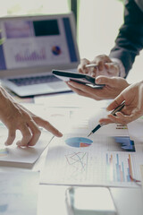 
Group of business people holding pen brainstorm financial analysis with financial graph document...