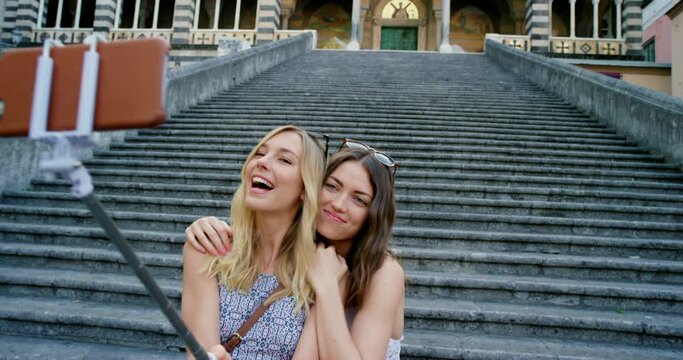 Phone selfie of travel friends at building, concrete stairs or Amalfi Cathedral Church for sightseeing adventure of Italy architecture. City tourist, selfie stick and happy people with memory picture
