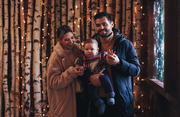 family with a baby in a cozy house in winter