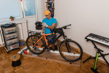 Male mechanic fixing bicycle seat before start the ride