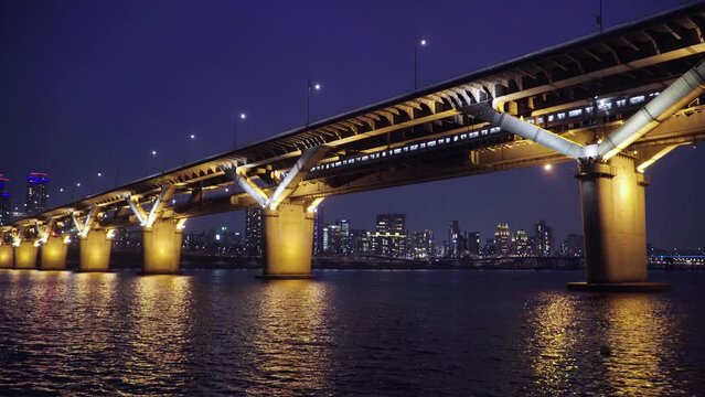 Night view taken at night, Seoul's subway passing through a bridge over the Han River