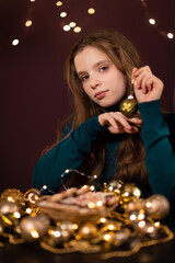 beautiful girl with New Year's cookies on the background of New Year's lights.