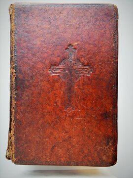 old church book in a leather cover on a light background
