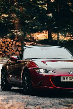 Vertical shot of a Mazda MX5 red car in nature