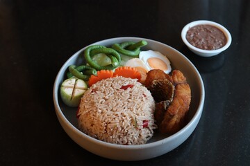 Thai style food, fried rice with chili paste with mix vegetable and  fried fish