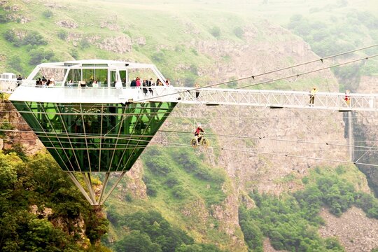 Dashbashi, Georgia- 19th JUne, 2022: woman ride zip bike over valley in beautiful caucasus mountains