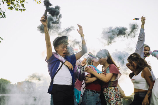 Happy friends enjoying while dancing together during LGBTQIA rights parade