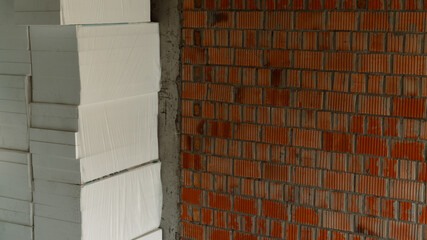 Styrofoam and a brick wall