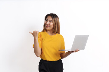Hot asian pretty young woman smiling isolated on white, yellow t-shirt, using laptop