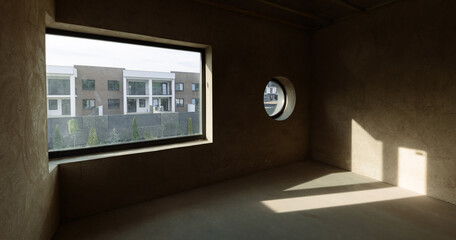An empty room in a new building with a round and panoramic window