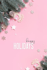 Happy Holidays greeting card on pink background with xmas new yaer decorations. Winter greeting card
