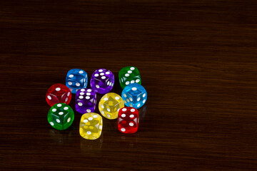 Transparent Coloured Gaming Dice on a Polished Wooden Surface
