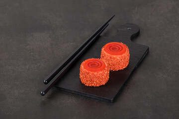 Vegan Tomato mousse cream appetizer of small round cylindrical shape with spiral jelly, on a...