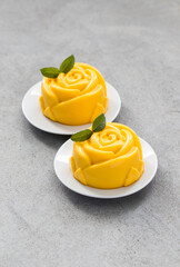 Pumpkin Cream pudding, Panna Cotta in the shape of a rose, on a plate. Light background	