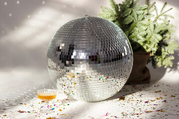 Christmas tree and mirror disco ball in white studio