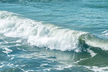 Background with sea waves. White foam on the surface of the water.