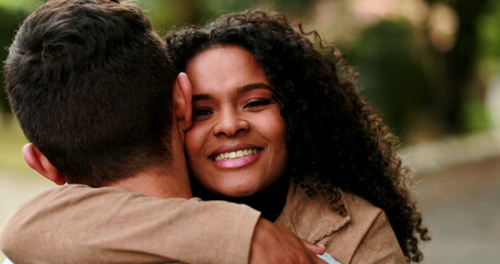 Black woman running and embracing man. Joyful girl hugging boyfriend