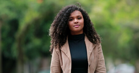 Confident black woman walking forward. Elegant millennial African person