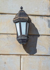 Rusting Vintage Gas Lamp on an Ancient Granite Wall.