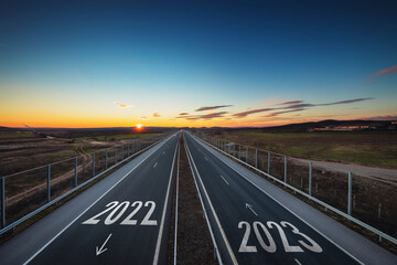 Fototapeta premium Driving on open highway road at beautiful sunny day to new year 2023, aerial view, transportation, logistic, travel and lifestyle concept