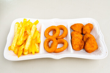 Fried Chicken breast hot crispy strips crunchy chicken tenders  isolated on white background.Nuggets isolated on white background on a plate