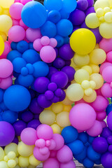 Bright abstract background of jumble of rainbow colored balloons, celebrating