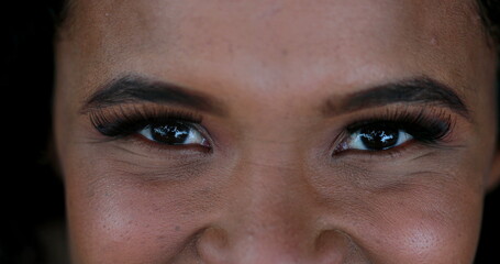 African girl close-up eyes looking at camera, mixed race woman closing and opening eyes