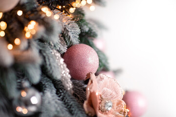 Christmas ball, Christmas decoration hanging on the Christmas tree, close-up. A garland glows nearby