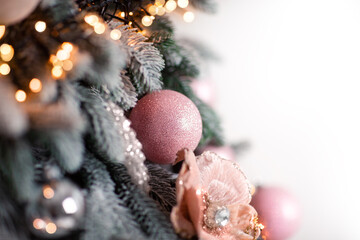 Fototapeta na wymiar Christmas ball, Christmas decoration hanging on the Christmas tree, close-up. A garland glows nearby
