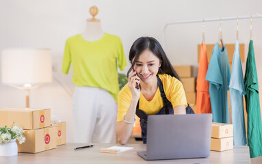 Portrait young attractive Asian female owner startup business working with box at home prepare...