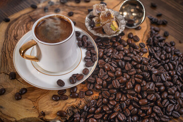 Hot Turkish coffee on wooden floor, Turkish delight next to it. 