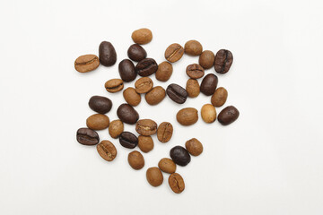Lightly roasted coffee beans and high roasted coffee beans together, close-up