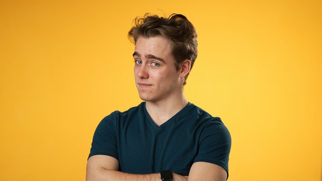 Portrait of confident smiling happy young hipster man 20s isolated on solid yellow background with copy space in studio