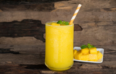 Orange juice fruit smoothies yogurt drink yellow healthy delicious taste in a glass slush for weight loss on wooden background.
