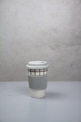 A reusable cup on a gray background. Smart consumption